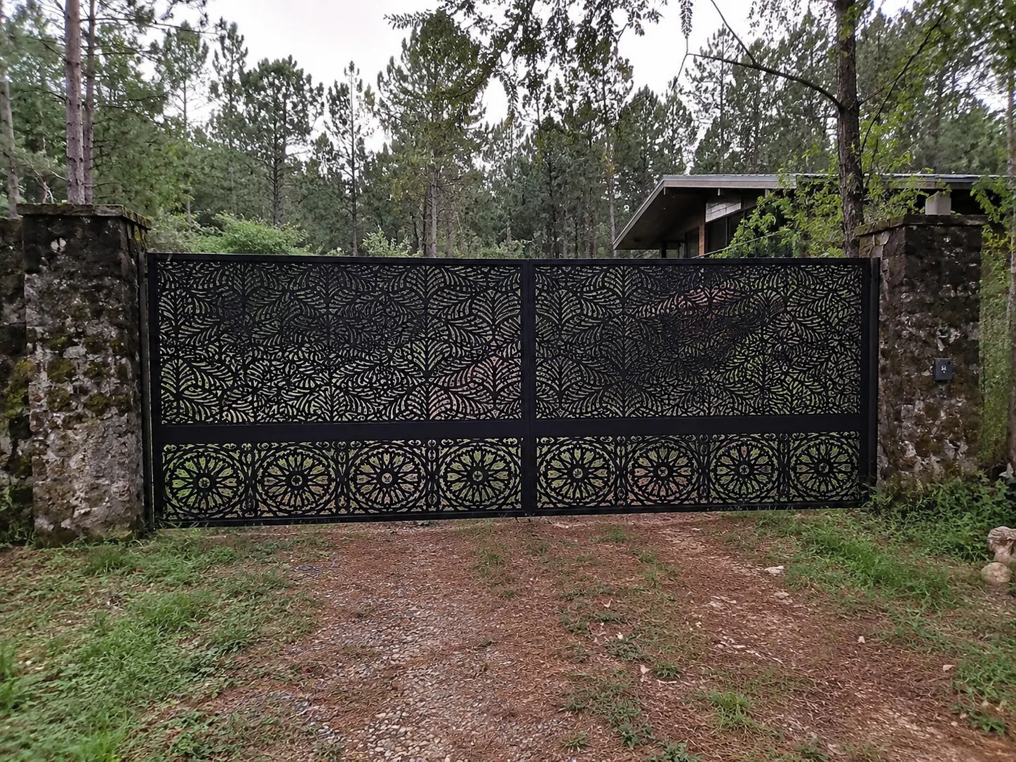 Portón de acceso con patrón vegetal en bosque